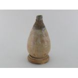 A Japanese studio bottle-shaped pot with striations around the tapered neck, transparent pink