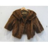 A short bolero style brown mink fur coat by Emba Pastel, with beige patterned silk lining, three