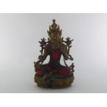 A cast figure of Buddha seated, the left hand raised in blessing, clad in a suit of red and