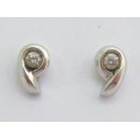 A pair of diamond ear studs, each stud set to the centre with a 0.10 carat stone, butterfly