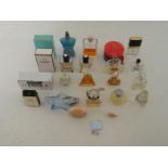 A group of 24 perfume bottles and atomisers, approximately 9 with part contents (3 in original