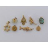 A mixed lot of charms, including one 9 carat gold articulated fish, fully hallmarked, 4gms; a