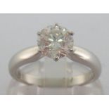 An 18 carat white gold and single stone diamond ring, the central round brilliant cut approx. 1