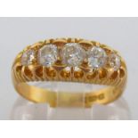 An 18 carat gold and five stone diamond ring, the graduated old cut brilliants totalling approx. 0.