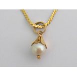 A single cultured pearl pendant, the cultured pearl 7.1mm diameter, the yellow metal bale stamped ‘
