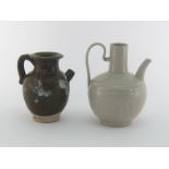 A Chinese water pot with tall neck , strap handle and incised and impressed lotus leaves around