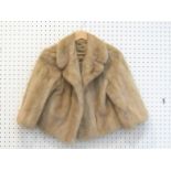 A short length silver mink fur coat by James Furs, Mayfair, London, with beige satin lining