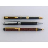 Two Waterman marbled lacquer ballpoint pens, together with a Marksman example (3)