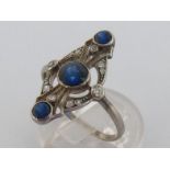 An Art Deco sapphire and diamond plaque ring, the navette shaped open work mount centring on three