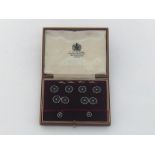 An Art Deco gold, onyx and diamond dress set, including a pair of cufflinks, four buttons, two