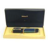 Pelikan, two marbled and black resin ball point pens, including a blue and green example, in a