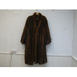A large three-quarter length brown mink coat, missing label, with brown satin lining, hook fitting