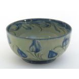 An early Mackintyre Moorcroft Florian ware bowl, the pale green body with tulip designs in blue