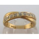 A 9 carat gold and diamond ring, the double cross-over band pave set with a single line of small
