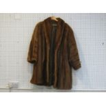 A large three-quarter length mink coat, missing label, with brown satin lining, hook fittings