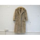 A small full-length silver mink fur coat by Norman Furs, London, size 8, the beige silk lining