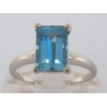 An aquamarine single stone ring, the rectangular step cut stone 8.8 x 5.85mm, the white metal