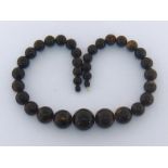 An amber bead necklace, composed of graduated spherical beads, 90gms