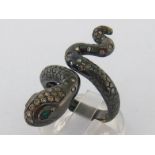 A diamond and emerald snake ring, the coated yellow metal (tests 18 carat gold) pave set across