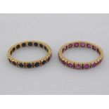 A pair of eternity rings, the first rub over set with a band of sapphires, the second similarly