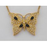 A sapphire and diamond butterfly pendant, the body and wings of the butterfly motif pave set overall