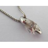 A single stone diamond pendant, the pear cut diamond approx. 0.5-0.6 carat, in canoe claw setting,