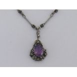 A Jugenstil silver and amethyst necklace, circa 1900, the centre piece claw set with an oval cut