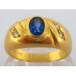 An 18 carat gold, sapphire and diamond ring, the central oval cut sapphire approx. 0.49 carat, the