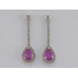 A pair of pink sapphire and diamond earrings, each drop set with a pear cut 7.1 x 5mm pink