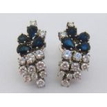 A pair of sapphire and diamond ear clips, each spray cluster composed of four pear cut sapphires