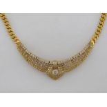 A diamond necklet, the central panel set overall with brilliants with baguette cut detail, the