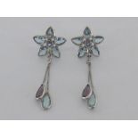 A pair of aquamarine and amethyst earrings, of flower design, suspended with two tassel drops,
