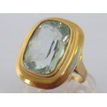 An aquamarine dress ring, the large rectangular cushion cut stone 7.97 carats, in a broad bezel