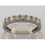 A seven stone diamond half hoop ring, the uniform band of brilliants totalling approx. 0.56 carat,