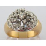 A diamond cluster ring, the swirl of brilliants centring on an approx. 0.14 carat principal stone,