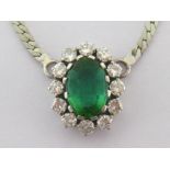 A green toumaline and diamond cluster pendant, the central oval cut stone 8.15 x 11.7mm in a