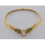 A French 18 carat gold, diamond, emerald and enamel choker, designed at the centre as two enamel and