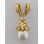 A South Sea cultured pearl and diamond pendant clasp, the pearl 12mm diameter, surmounted by a skirt