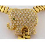 A diamond and emerald necklace, the sliding elephant motif pave set overall with uniform brilliants,