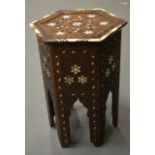 A LATE 19TH CENTURY EASTERN IVORY INLAID TABLE probably retailed by Liberty & Co. 1ft 10ins high.