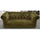 A GREEN UPHOLSTERED VICTORIAN DESIGN SOFA.