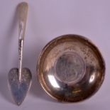 A 19TH CENTURY SILVER AND MOTHER OF PEARL CADDY SPOON together with a silver dish inset with a coin,