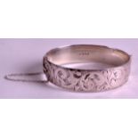 A VINTAGE HINGED SILVER BANGLE by Georg Jensen, engraved with flowers.