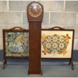 A 1930S GRANDMOTHER CLOCK together with a pair of Edwardian needlework fire screens. (3)