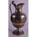 A 19TH CENTURY INDIAN SILVER EWER with cobra handle, decorated with buddhistic figures. 455 grams.