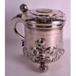 A MID 19TH CENTURY SWEDISH SILVER STEIN embossed in relief with foliage and the top inset with a