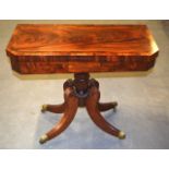 A GOOD REGENCY MAHOGANY AND WALNUT FOLD OVER CARD TABLE with bold column support upon four splayed