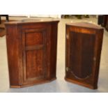 A 19TH CENTURY OAK CORNER CUPBOARD together with another similar cupboard. (2)