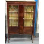 AN EDWARDIAN MAHOGANY DISPLAY CABINET with twin panel doors.