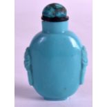 AN EARLY 20TH CENTURY IMIATION TURQUOISE SNUFF BOTTLE AND STOPPER with mask head handles. 2.75ins